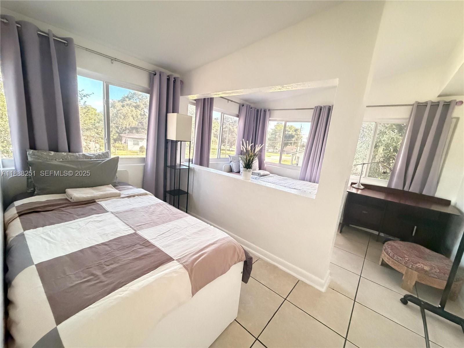 3 Southwest 7th Avenue Dania Beach, FL 33004 - Photo 19 of 25 a bedroom with a bed and a couch