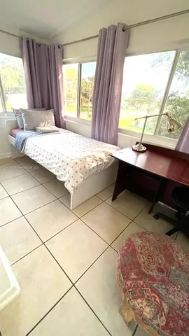 a view of a hallway with wooden floor and closet
