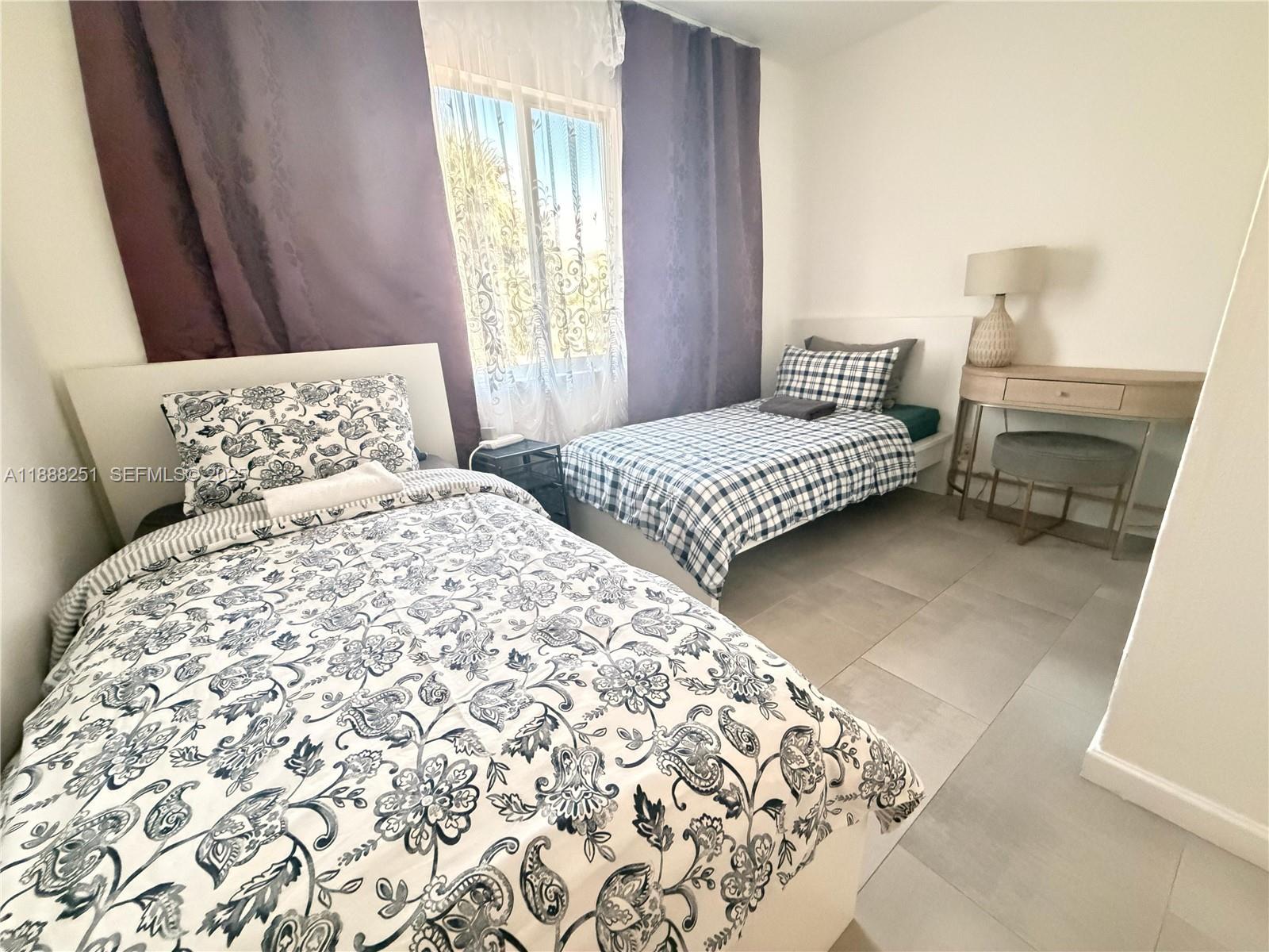 3 Southwest 7th Avenue Dania Beach, FL 33004 - Photo 24 of 25 a bedroom with a bed and a window