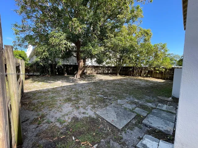 a view of backyard with green space