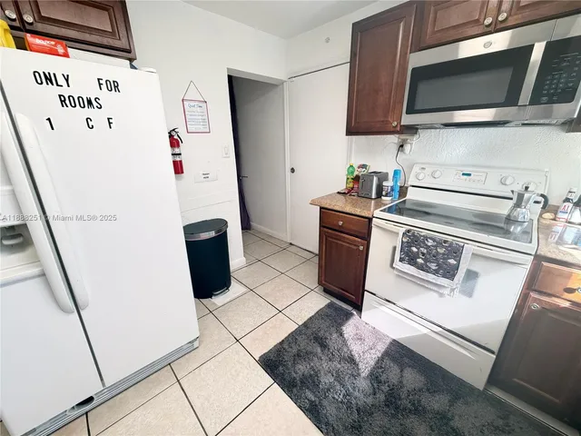 a kitchen with stainless steel appliances a stove a microwave and refrigerator