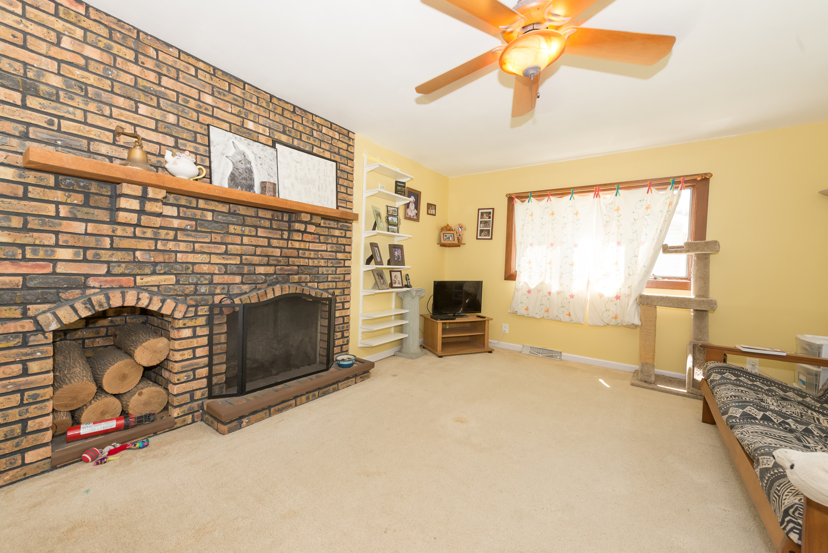 1S183 Valley Road Lombard, IL 60148 - Photo 12 of 25 a living room with furniture a fireplace and a flat screen tv