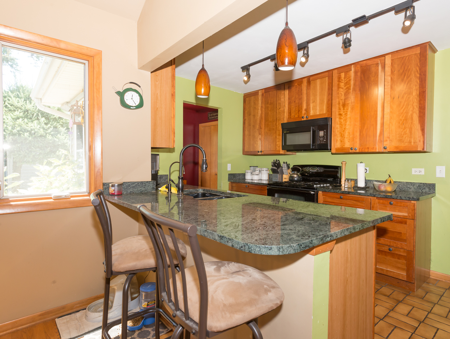 1S183 Valley Road Lombard, IL 60148 - Photo 4 of 25 a kitchen with a stove a sink and a microwave