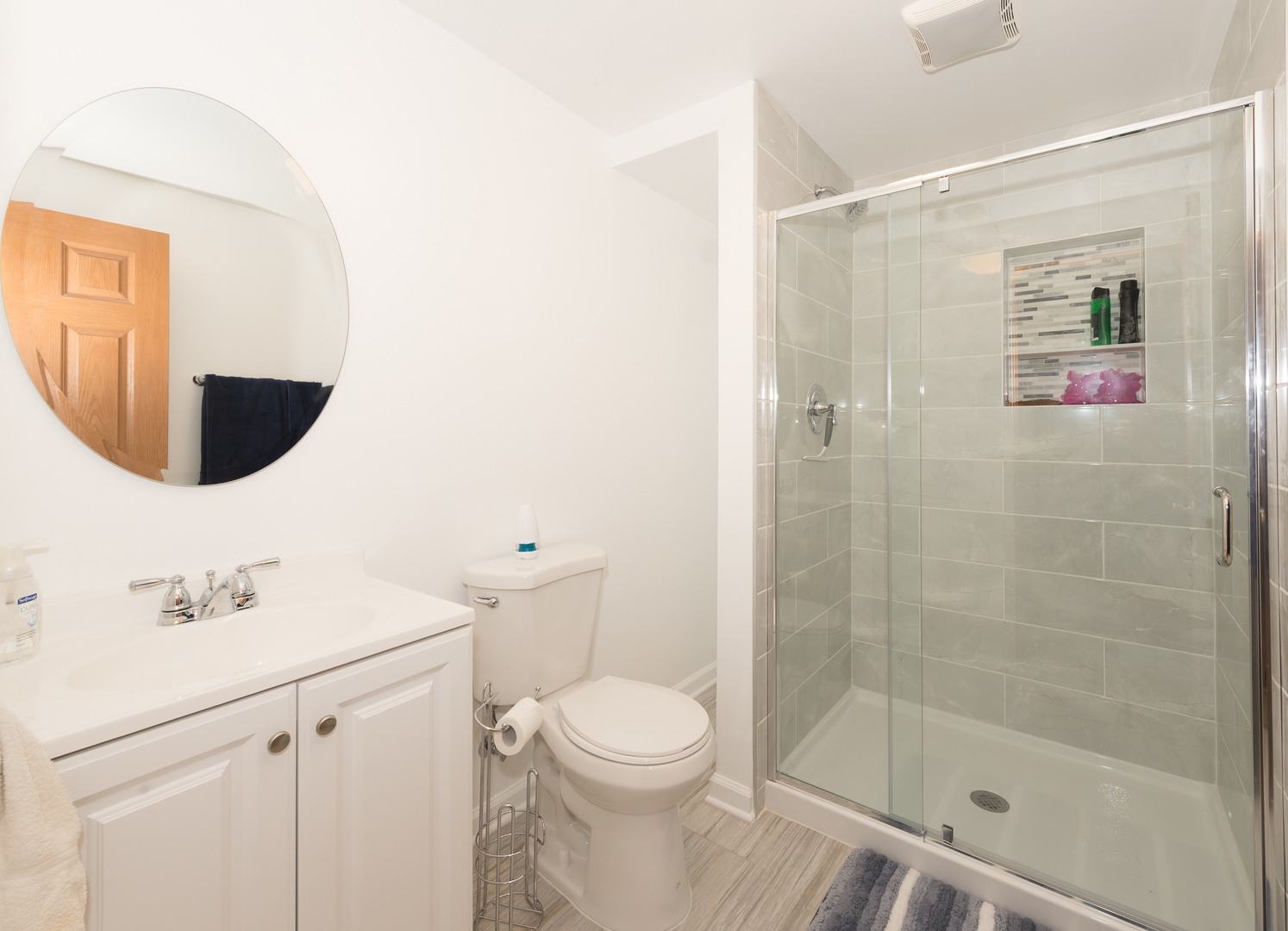 1S183 Valley Road Lombard, IL 60148 - Photo 10 of 25 a bathroom with a sink a toilet and shower