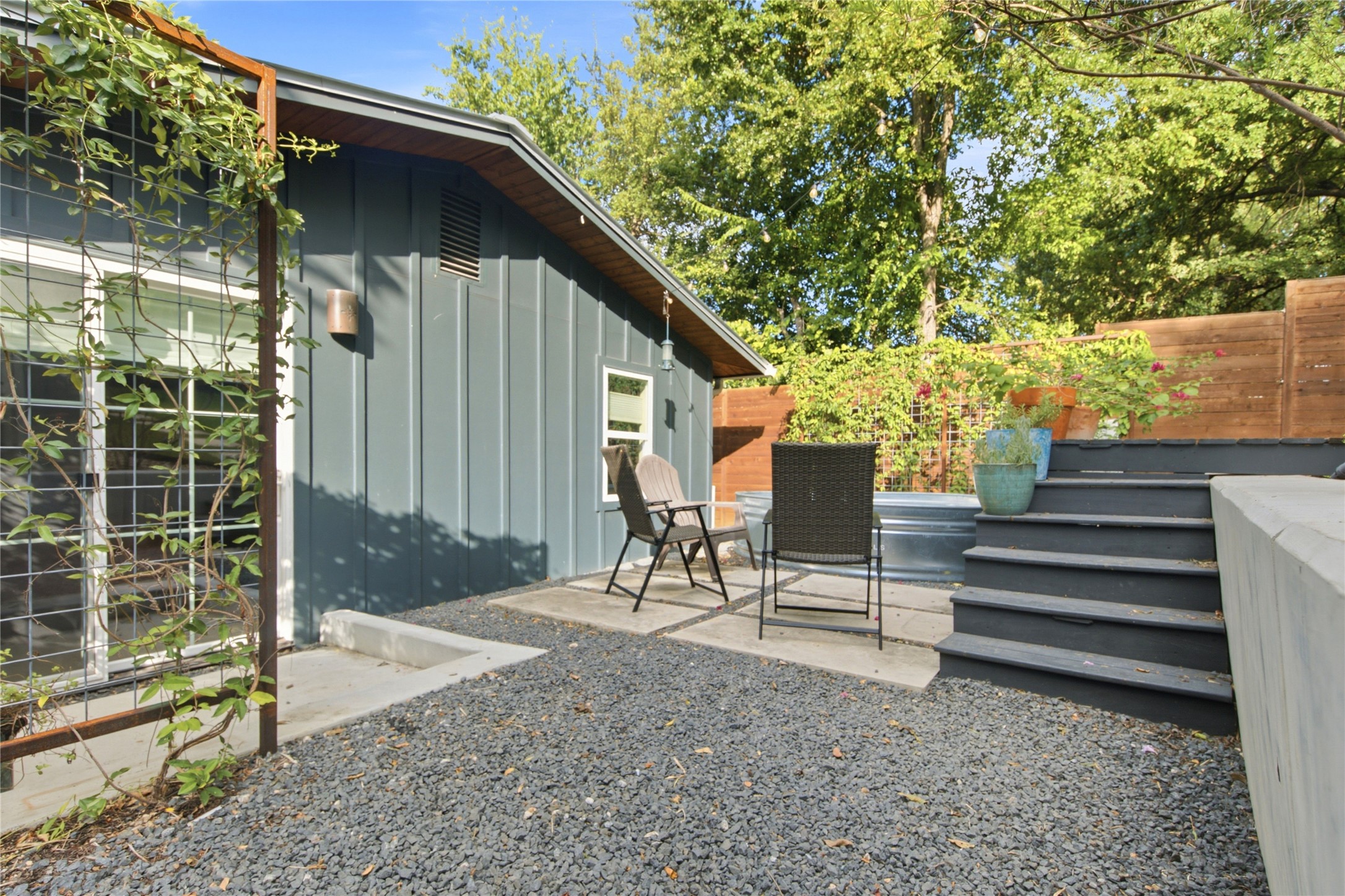 5600 Ledesma Road Austin, TX 78721 - Photo 25 of 36 Board and batten siding meets gravel pathways in this private terraced outdoor space.