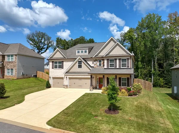 a front view of a house with a yard