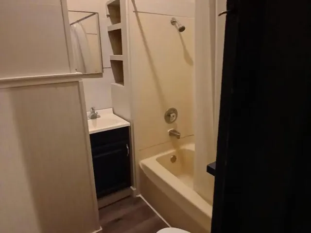 a bathroom with a bathtub and sink