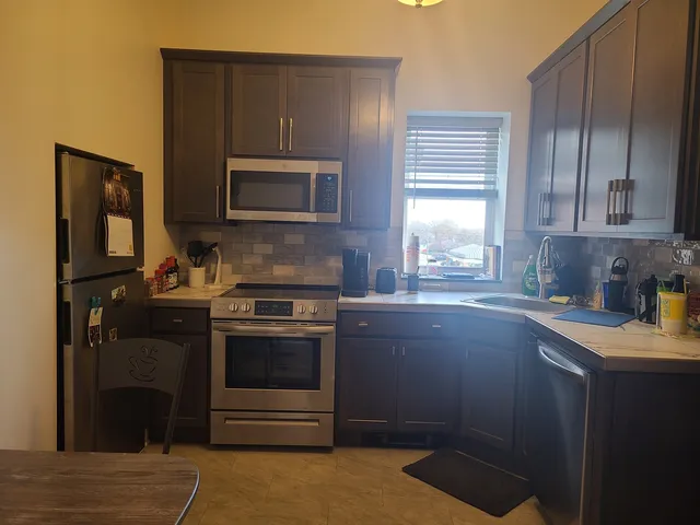 a kitchen with a stove microwave and sink