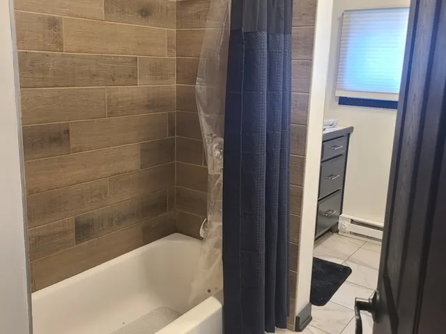 a bathroom with a bathtub and a shower