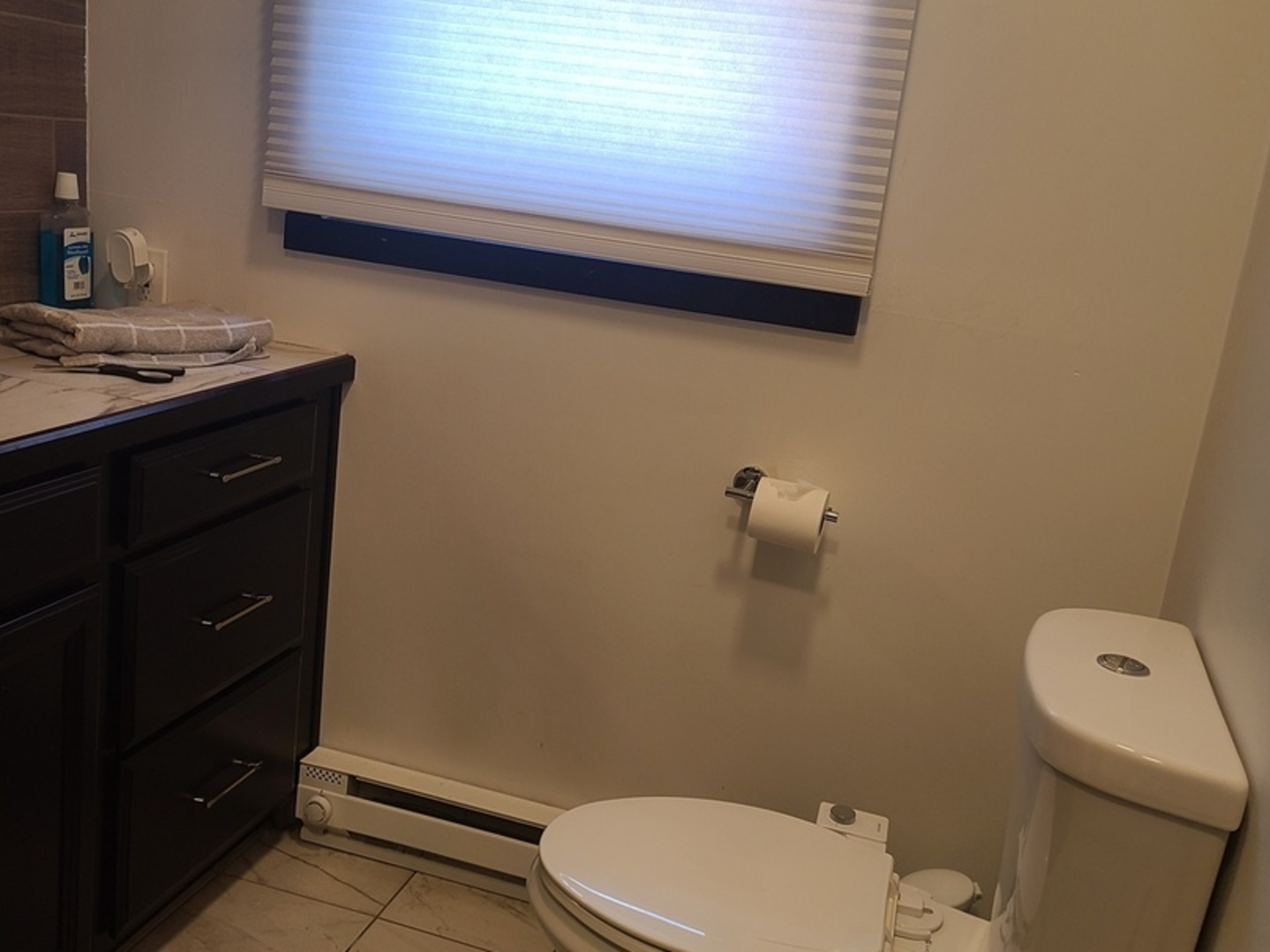 1818 4th Street Peru, IL 61354 - Photo 7 of 36 a bathroom with a toilet a sink a vanity and mirror