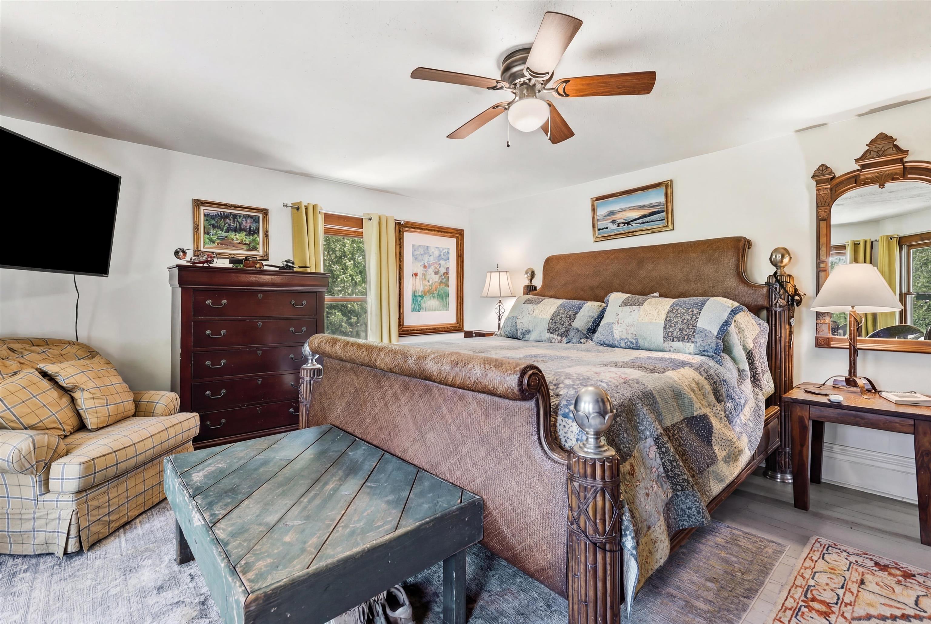 2181 South Irish Hollow Road Galena, IL 61036 - Photo 31 of 48 a bedroom with a bed a couch and a chandelier