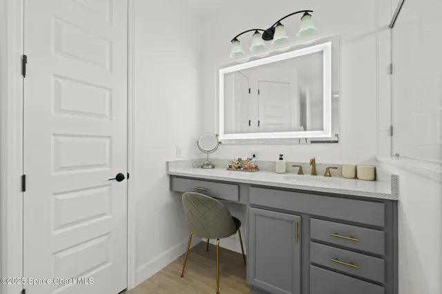 a bathroom with a granite countertop toilet sink and mirror