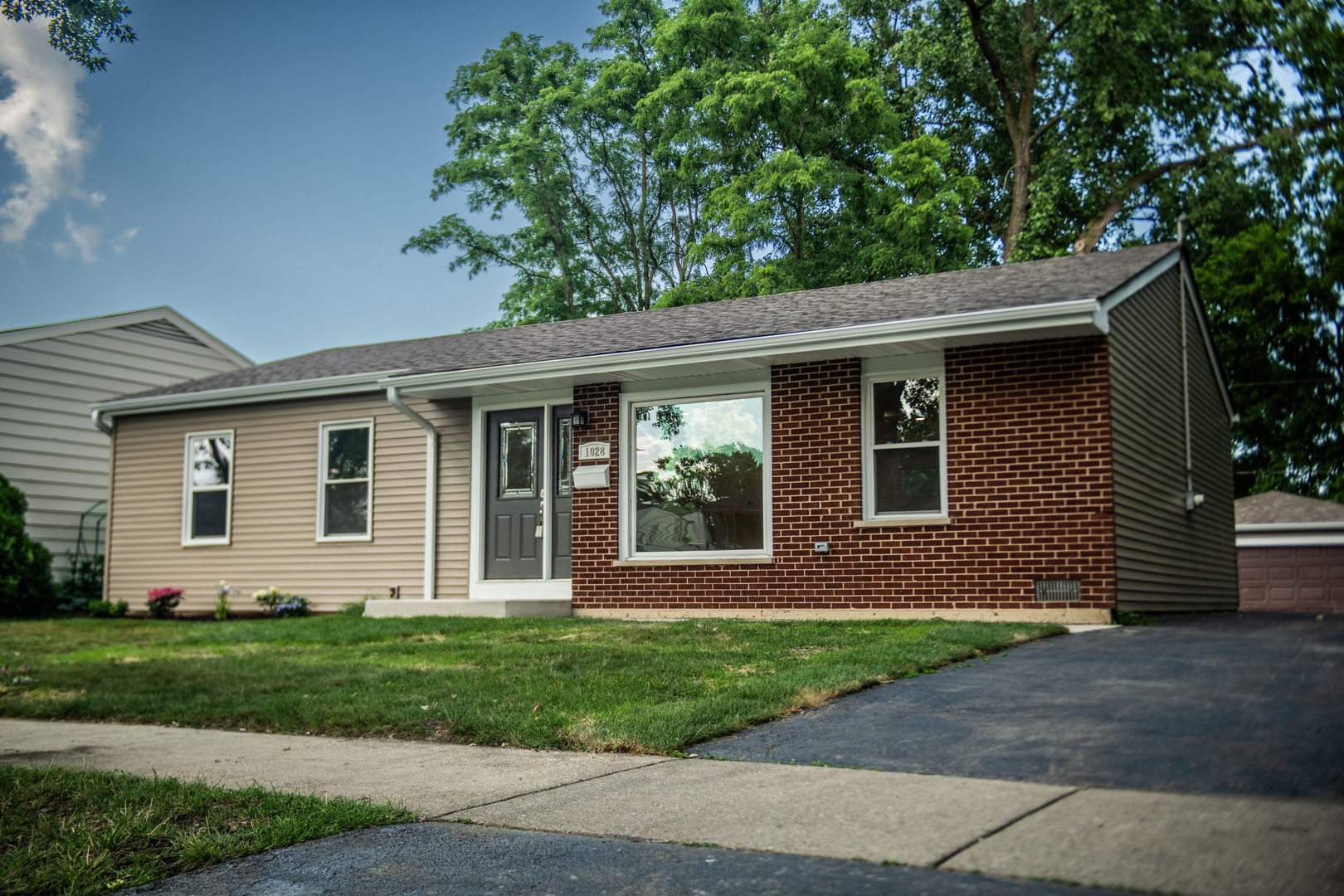 a front view of a house with a garden