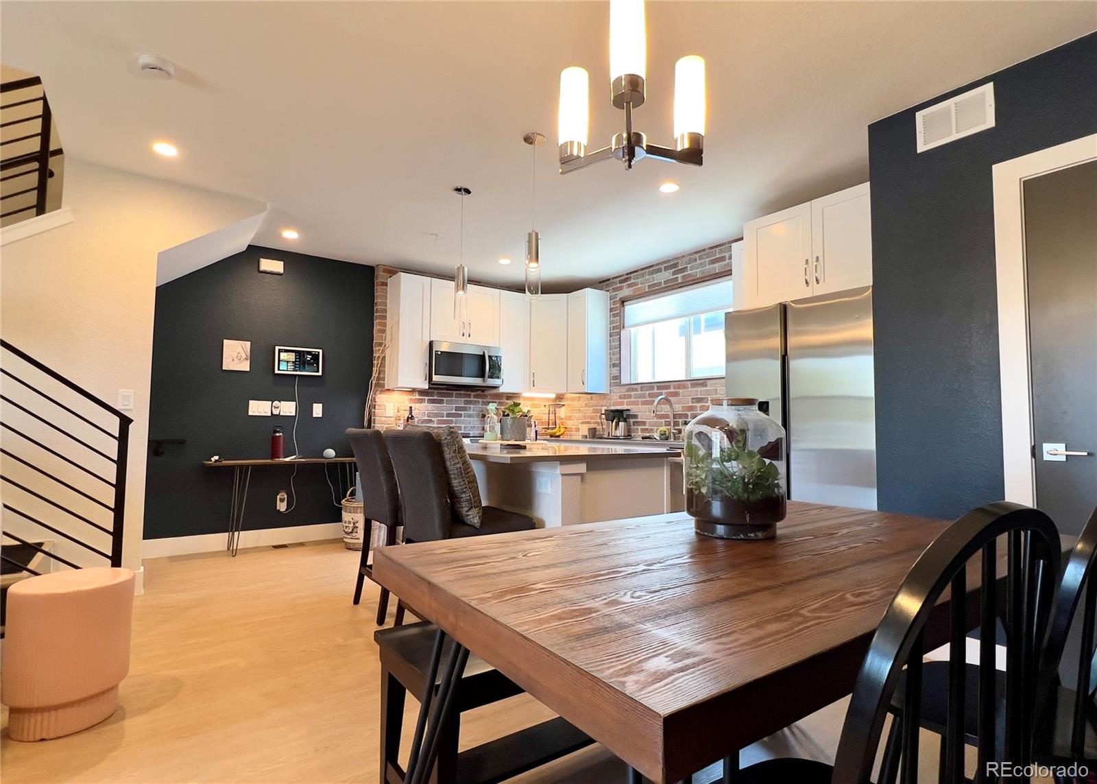 6228 West 38th Avenue Wheat Ridge, CO 80033 - Photo 9 of 38 a kitchen with a dining table chairs and refrigerator