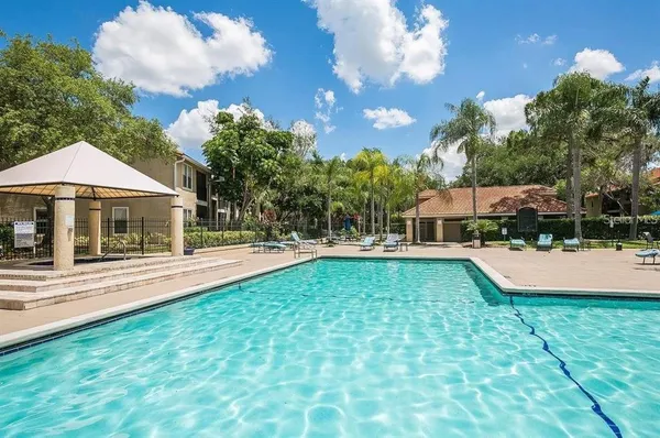 a view of a house with swimming pool and sitting area
