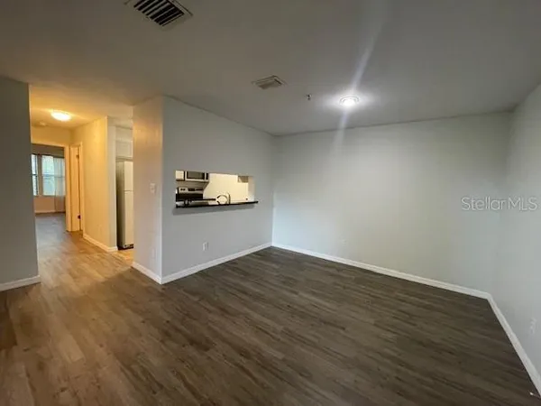 a view of a kitchen with a sink and a refrigerator