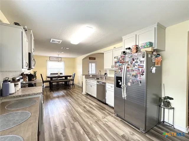 a view of a dining room with furniture and wooden floor