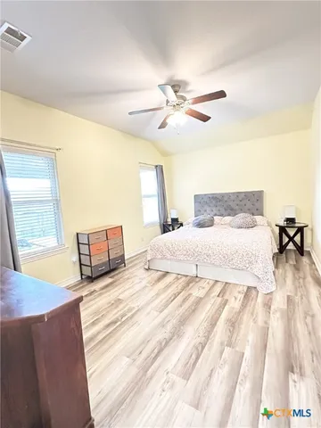 a bathroom with a tub a sink and a window