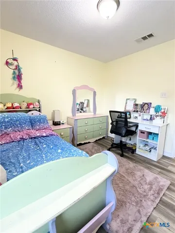 a bedroom with a workspace