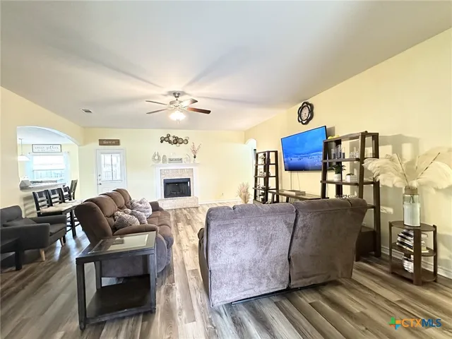 a living room with furniture a large window and a chandelier