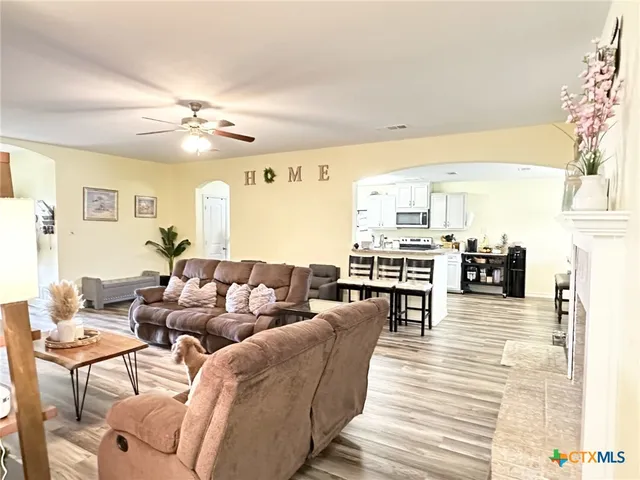 a living room with lots of furniture and a chandelier