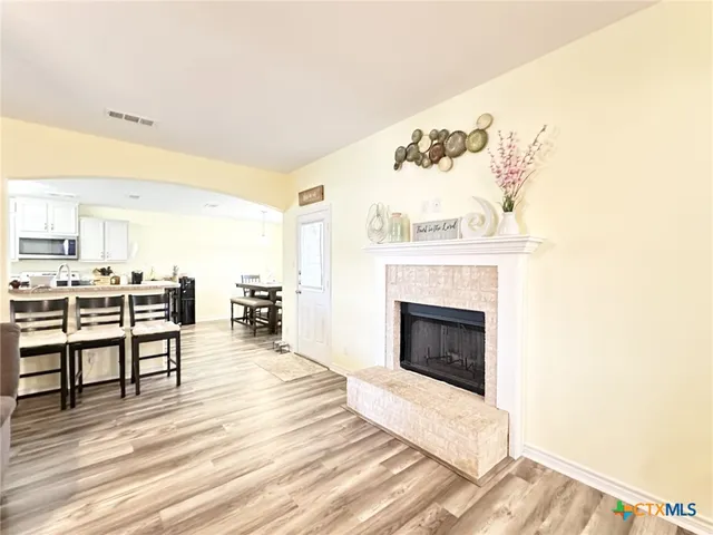 a large kitchen with a lot of counter space and a wooden floor