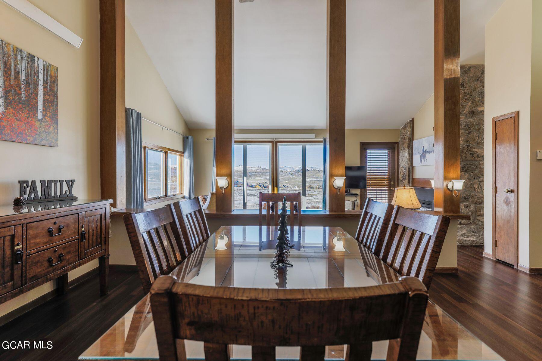 a view of a a dining room with furniture window and wooden floor