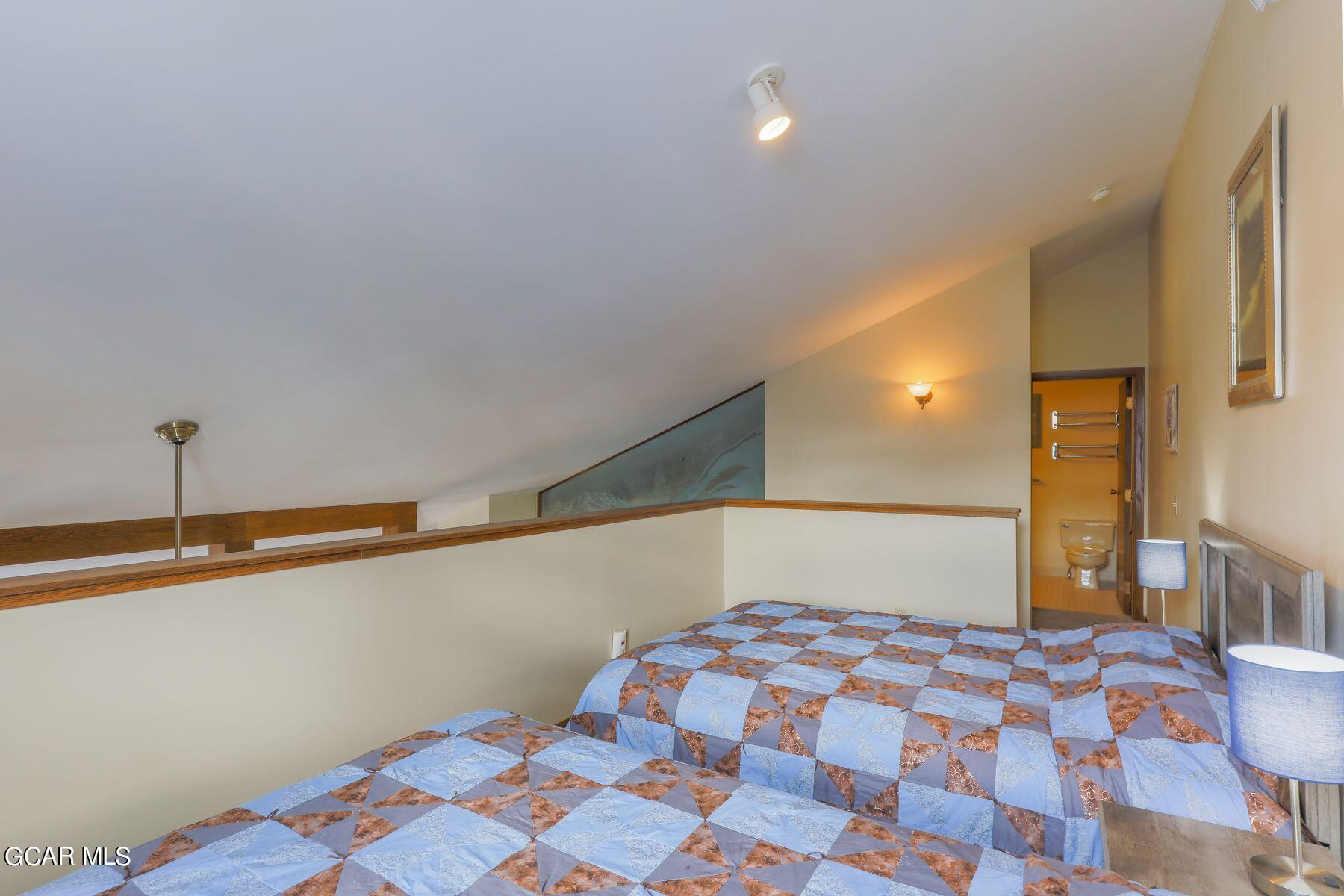 96 Mountainside Drive, Unit B 58 Granby, CO 80446 - Photo 12 of 42 a bedroom with a bed and a lamp