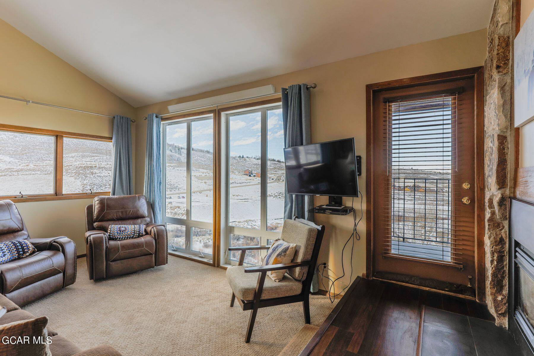 96 Mountainside Drive, Unit B 58 Granby, CO 80446 - Photo 14 of 42 a living room with furniture and a flat screen tv