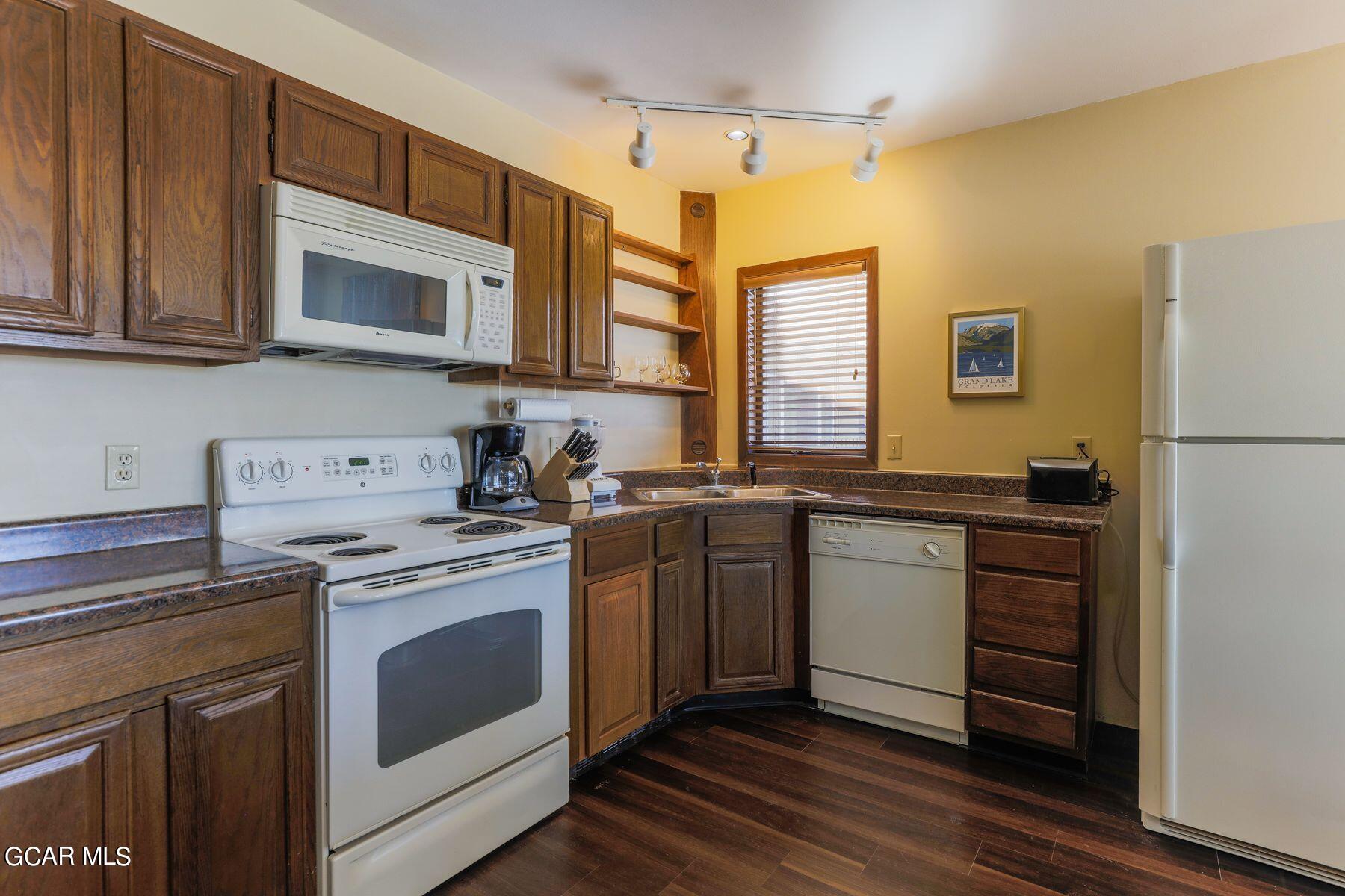 96 Mountainside Drive, Unit B 58 Granby, CO 80446 - Photo 16 of 42 a kitchen with stainless steel appliances granite countertop a stove a sink and a refrigerator