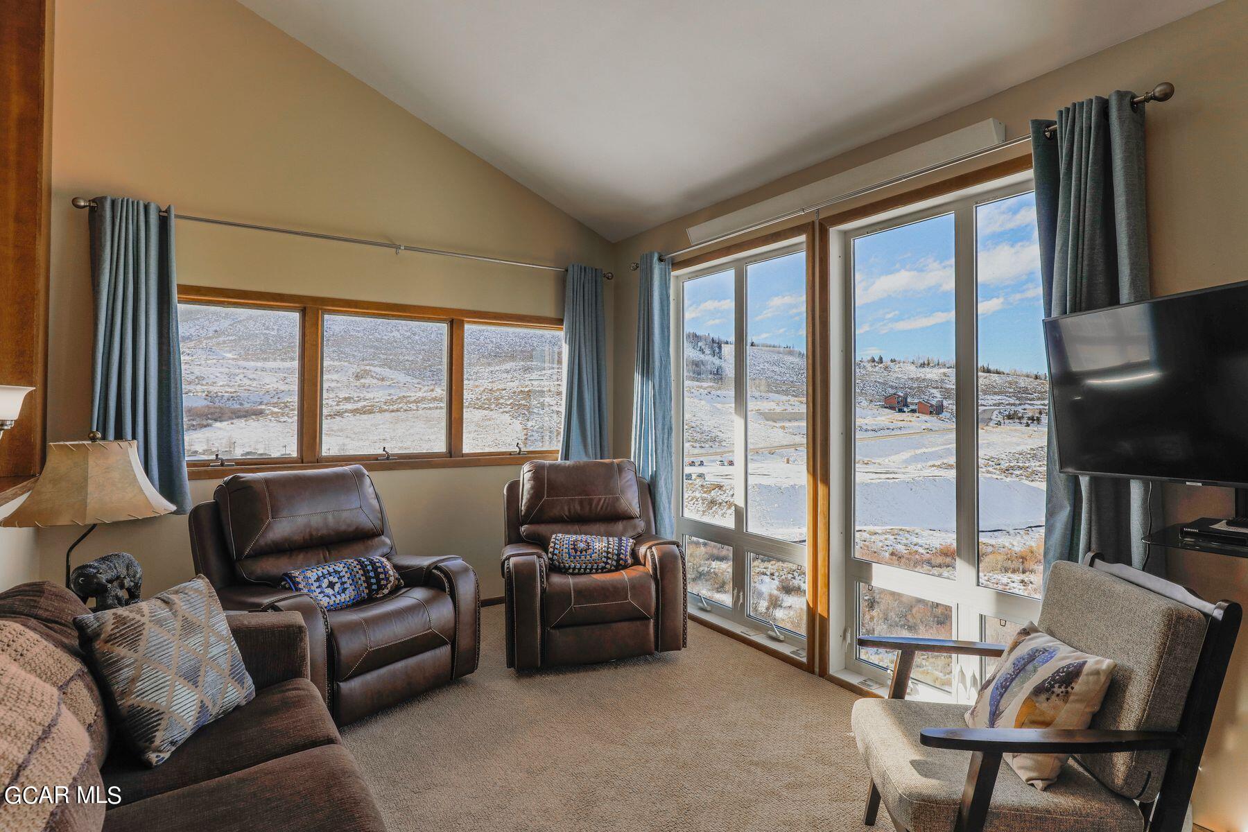 96 Mountainside Drive, Unit B 58 Granby, CO 80446 - Photo 2 of 42 a living room with furniture and a floor to ceiling window
