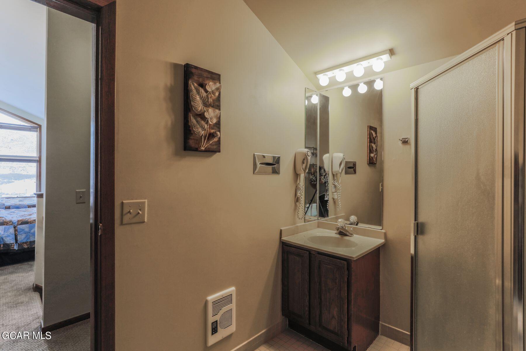 96 Mountainside Drive, Unit B 58 Granby, CO 80446 - Photo 24 of 42 a bathroom with a sink vanity and a mirror