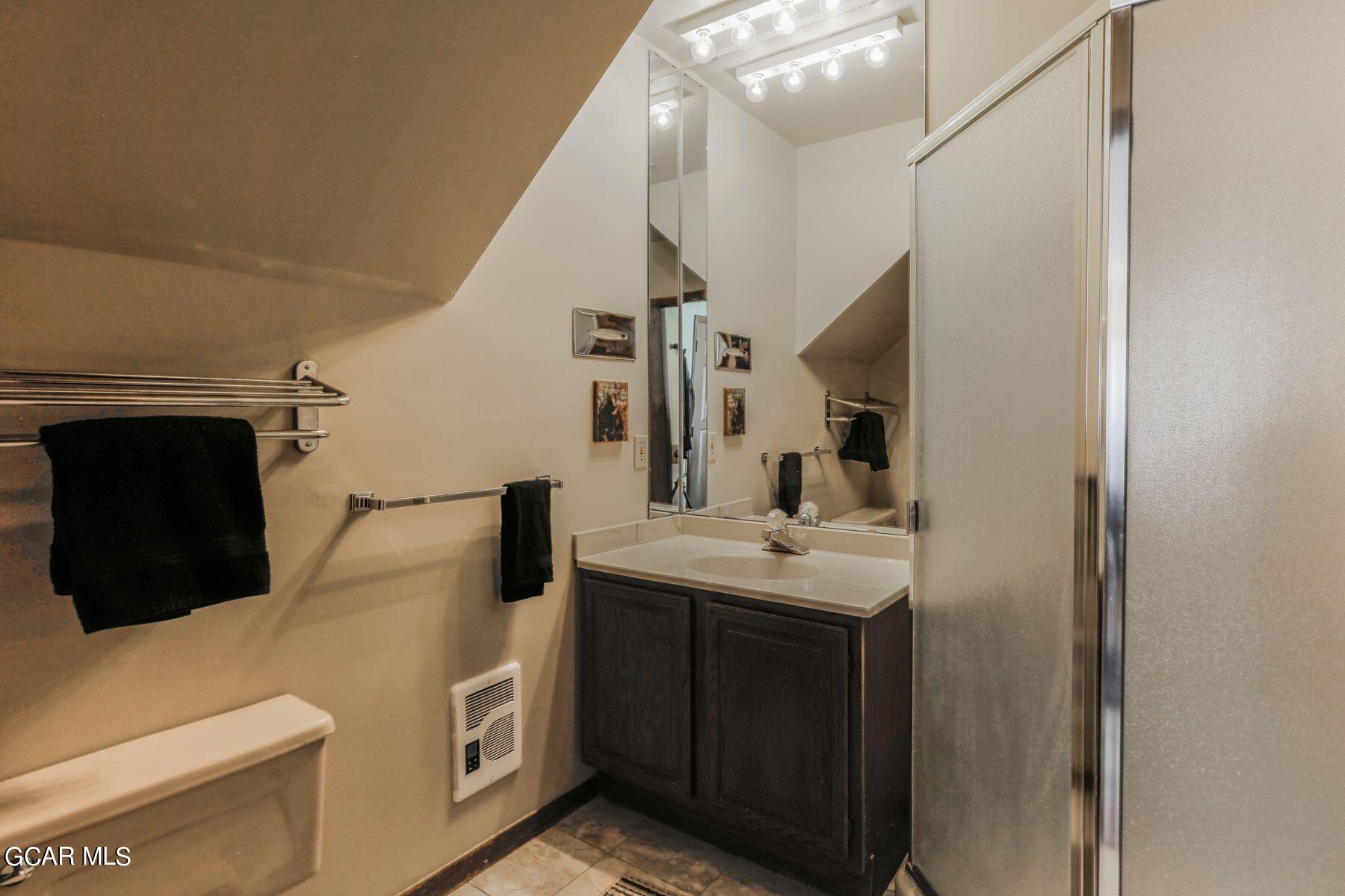 96 Mountainside Drive, Unit B 58 Granby, CO 80446 - Photo 26 of 42 a bathroom with a toilet sink and mirror