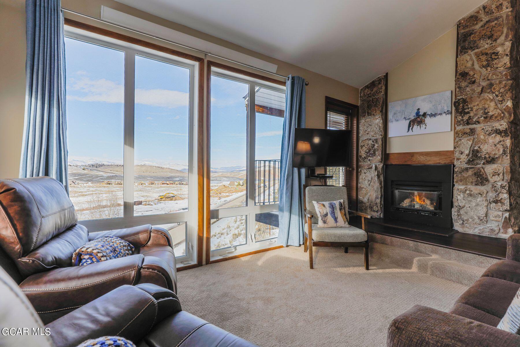 96 Mountainside Drive, Unit B 58 Granby, CO 80446 - Photo 3 of 42 a living room with furniture and a fireplace