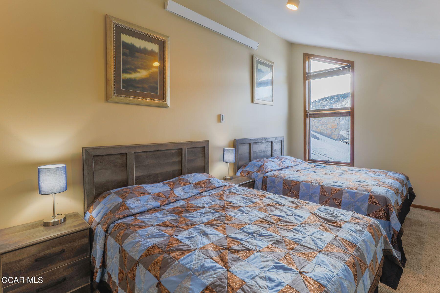 96 Mountainside Drive, Unit B 58 Granby, CO 80446 - Photo 5 of 42 a bedroom with a bed and lamp