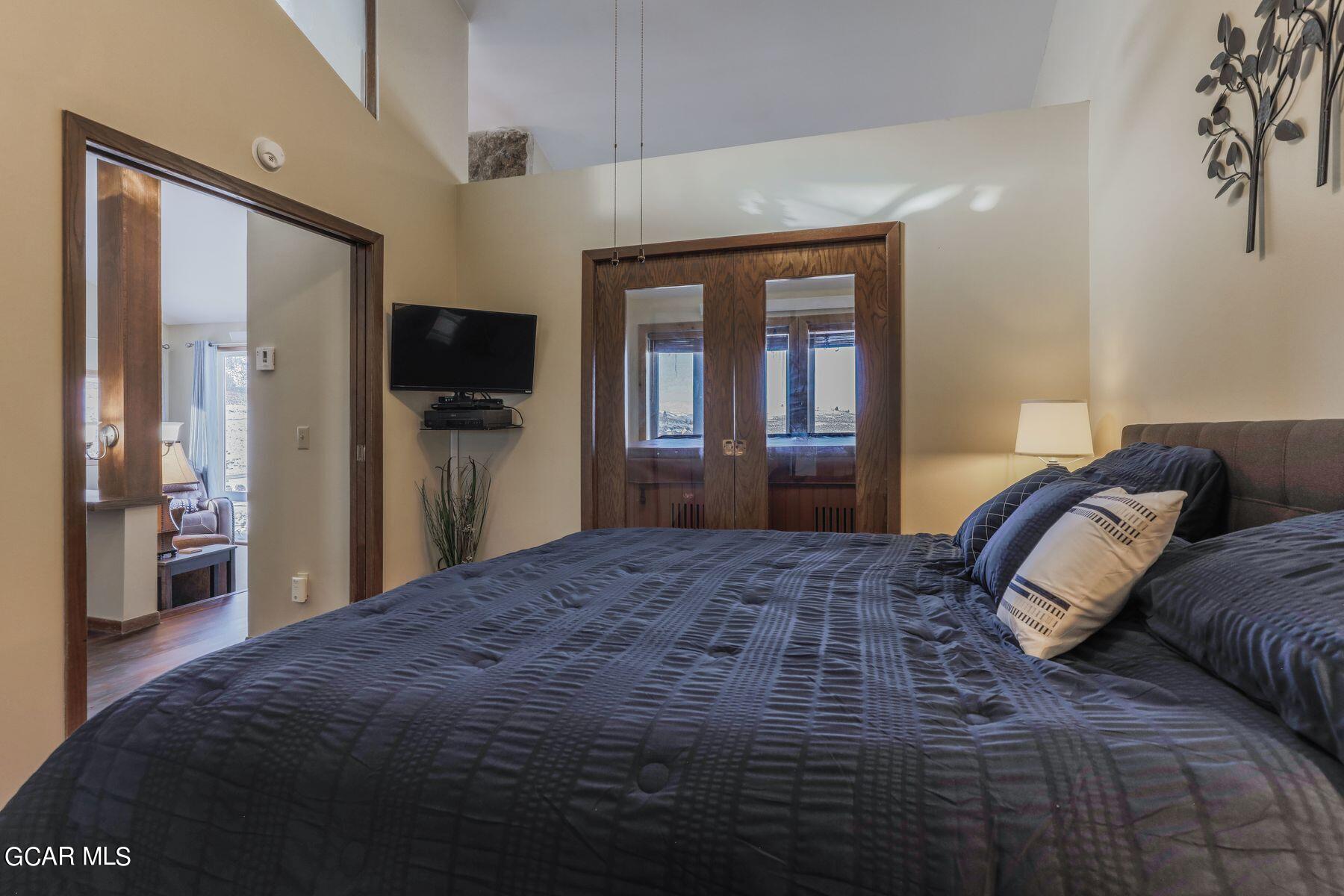 96 Mountainside Drive, Unit B 58 Granby, CO 80446 - Photo 8 of 42 a bedroom with a bed and a large mirror on dresser