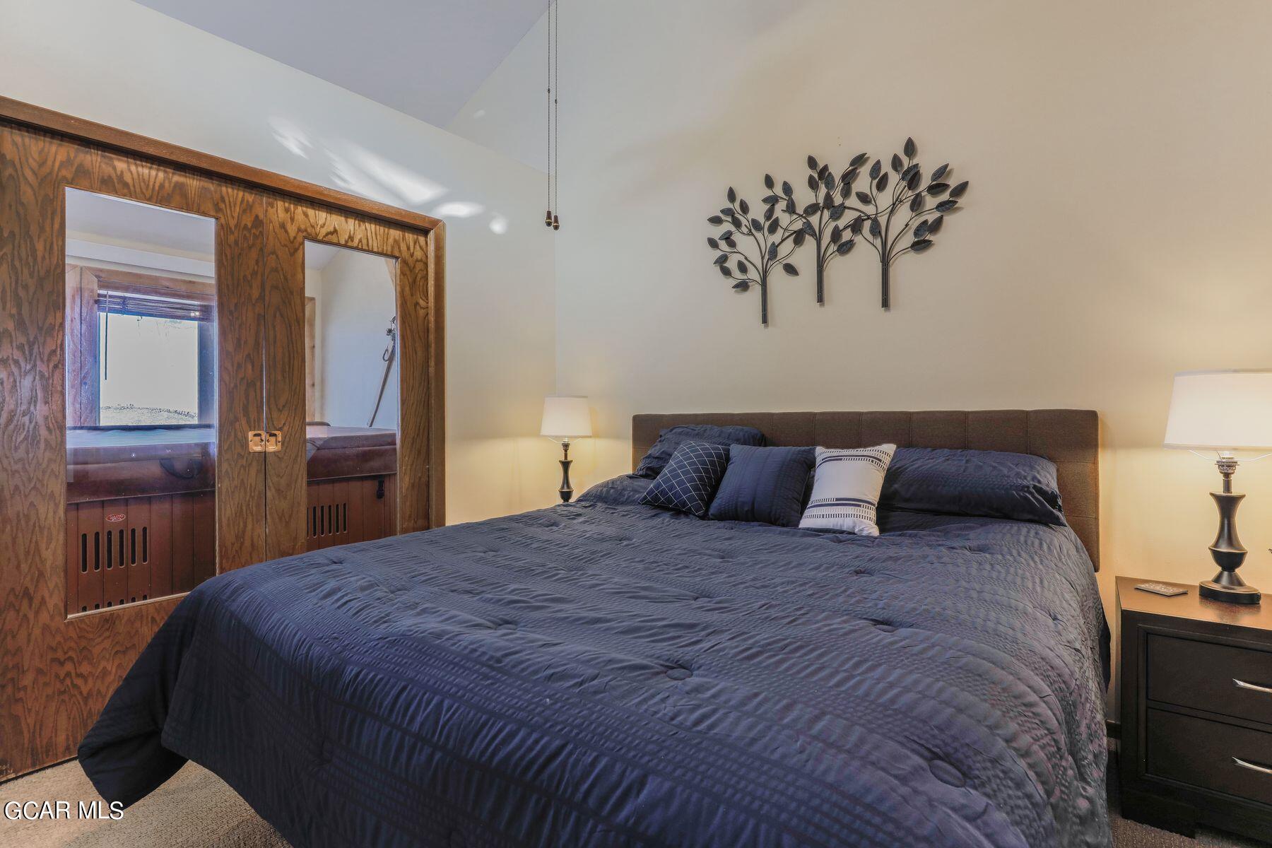 96 Mountainside Drive, Unit B 58 Granby, CO 80446 - Photo 9 of 42 a large bed sitting in a bedroom next to a window