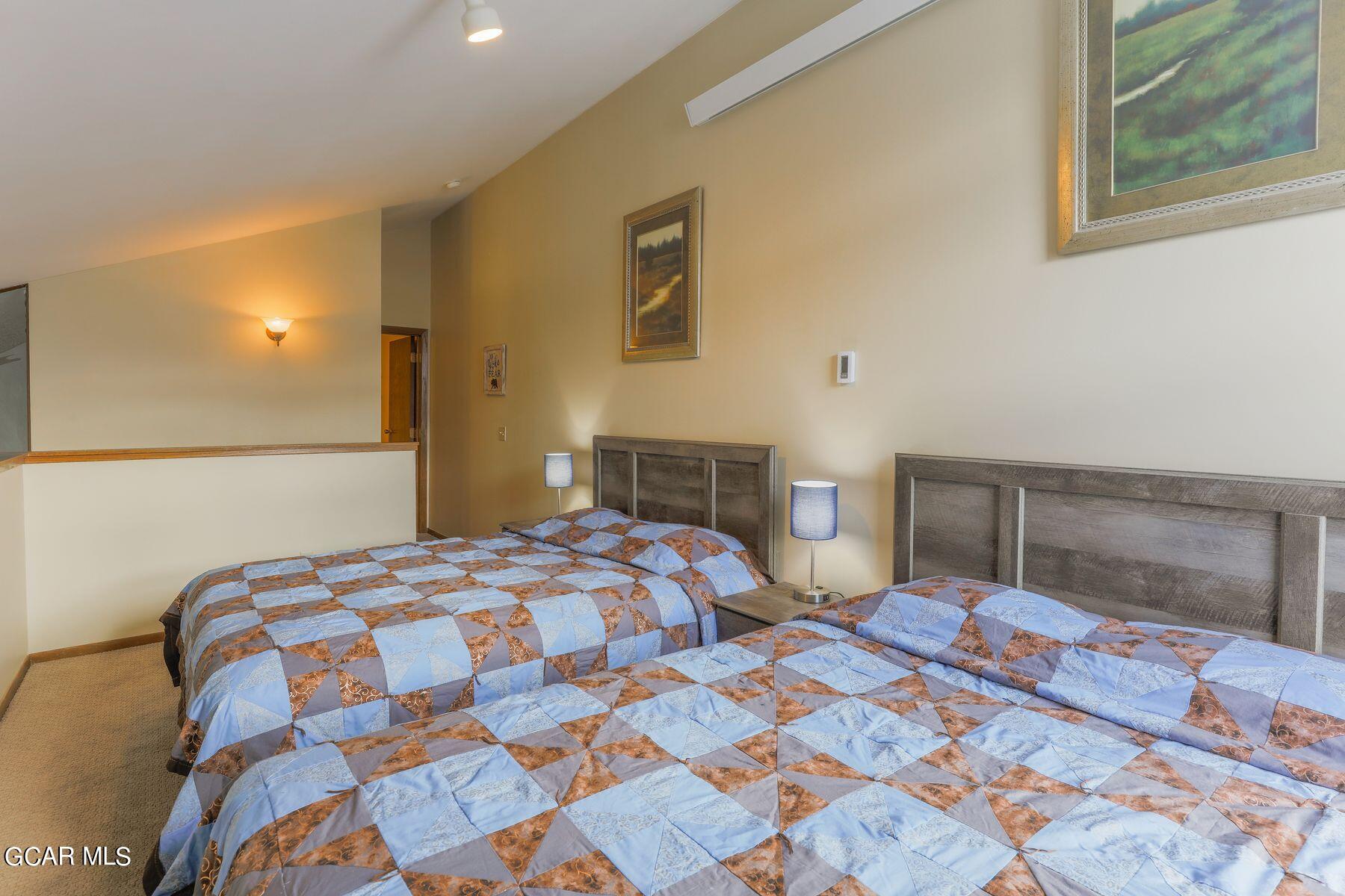 96 Mountainside Drive, Unit B 58 Granby, CO 80446 - Photo 10 of 42 a bedroom with a bed and a lamp