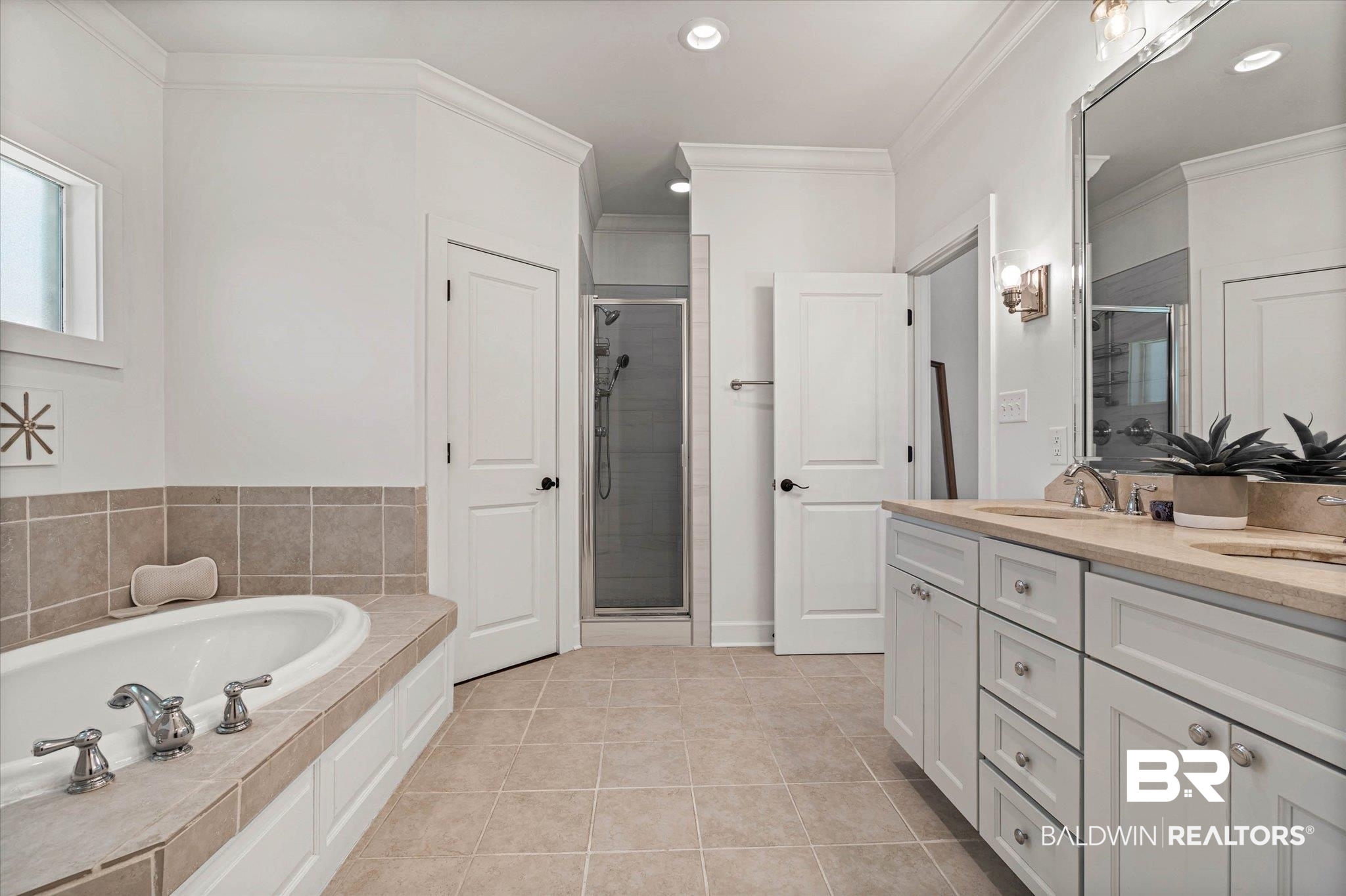 1052 Linlen Avenue Mobile, AL 36609 - Photo 12 of 22 Bathroom with double vanity, light tile patterned flooring, a stall shower, a garden tub, and ornamental molding