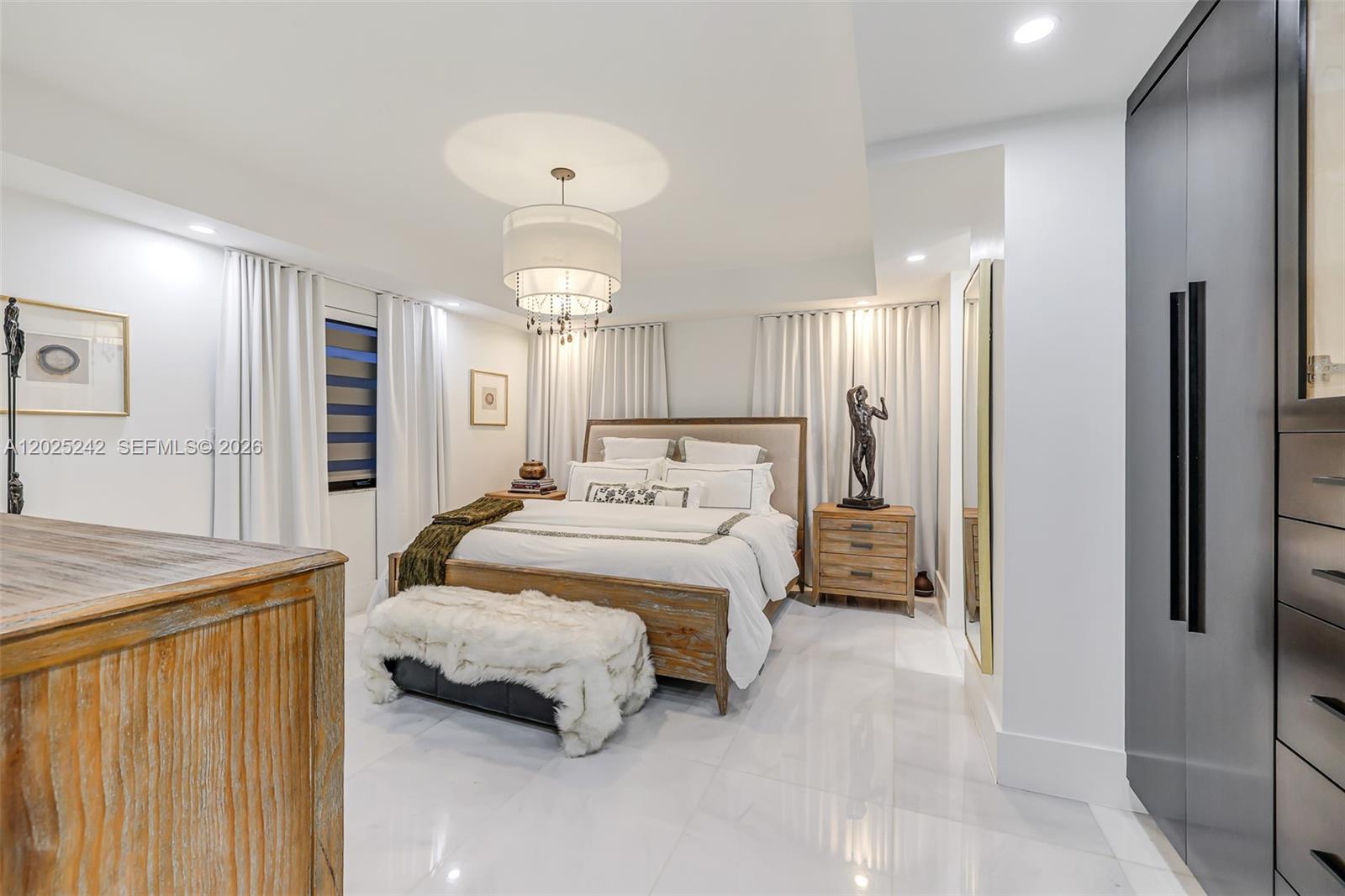 8761 Southwest 56th Street Miami, FL 33165 - Photo 31 of 90 a spacious bedroom with a bed and a refrigerator