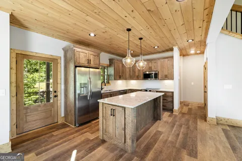 a kitchen with a stove a refrigerator and a sink
