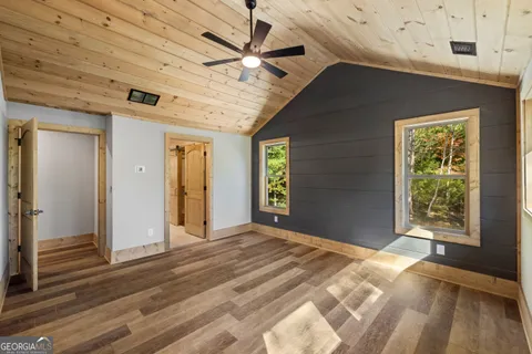 a view of a livingroom with a ceiling fan and window