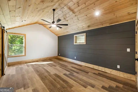 a view of a room with a ceiling fan and a window