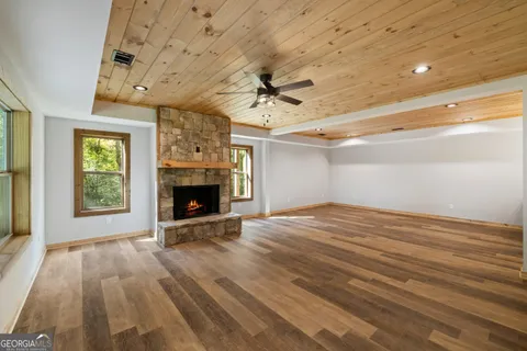 en empty room with windows and a fireplace