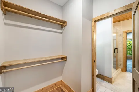 a view of a room with wooden floor