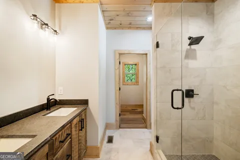 a bathroom with a granite countertop shower