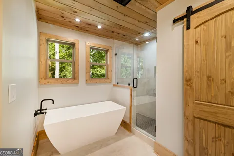 a bathroom with a bathtub and shower