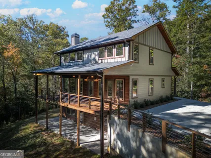 a view of a house with backyard and sitting area
