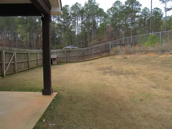 a view of a barn in the middle of a yard