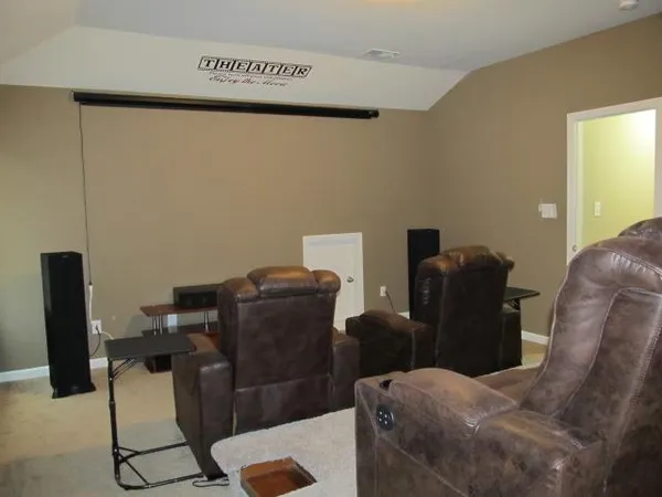 a bathroom with a granite countertop bathtub shower sink vanity and a toilet